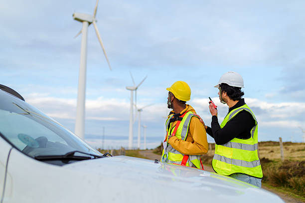 istock Engineers using walkie talkie inspecting wind turbines in wind power plant 2212965199