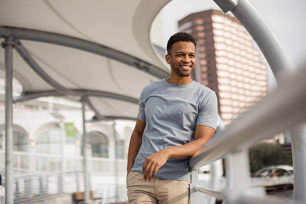 istock Young Man Smiling Outdoors Near Urban Architecture Under Stylish Canopy 2212966188