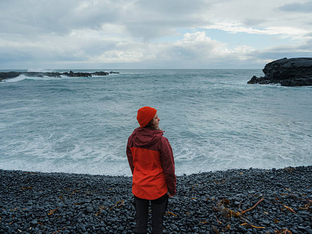 istock Woman enjoying dramatic  seaside view during trip to Iceland 2212973845