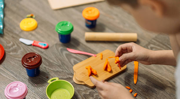 istock A child sculpts plasticine on a children's cutting board 2212974074