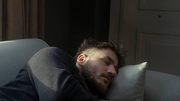 istock Young Man Suffering from Neck and Back Pain After Sleeping in an Uncomfortable Position 2212987306