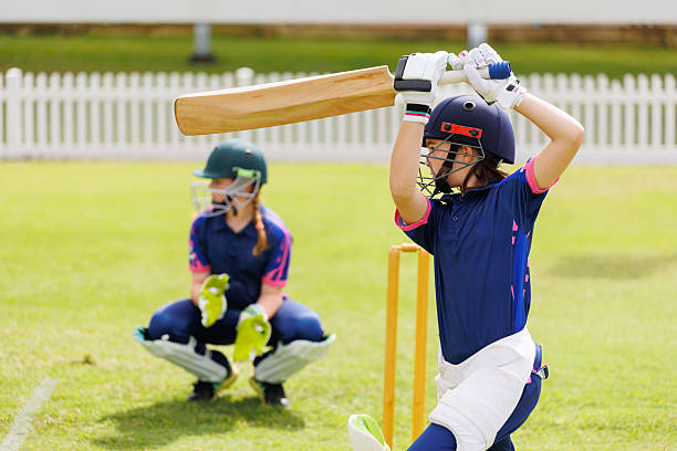 istock Young female cricket player playing a shot during a cricket match 2212992778