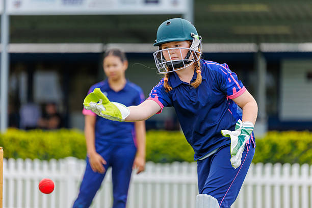 istock Female wicketkeeper in action during a cricket match 2212992884