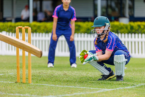 Female wicketkeeper in action during a cricket match