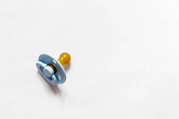 Blue pacifier placed on a white background, symbolizing baby care essentials. Captures the simplicity and necessity of infant accessories in a clean, minimal setting.