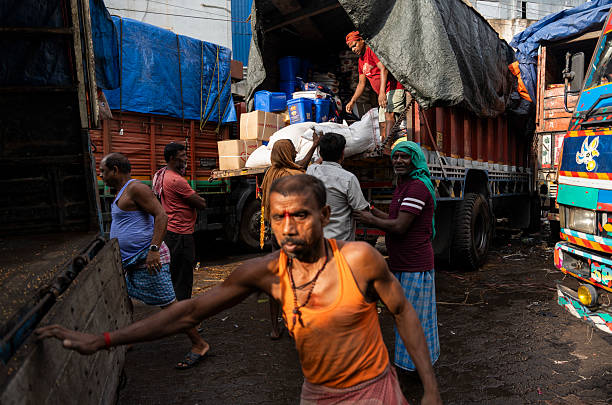 Labourers carries goods in a wholesale market, in Guwahati, India, on  May 1, 2025.   May Day or Workers Day is a global holiday celebrated on May 1st to honor workers and their contributions.