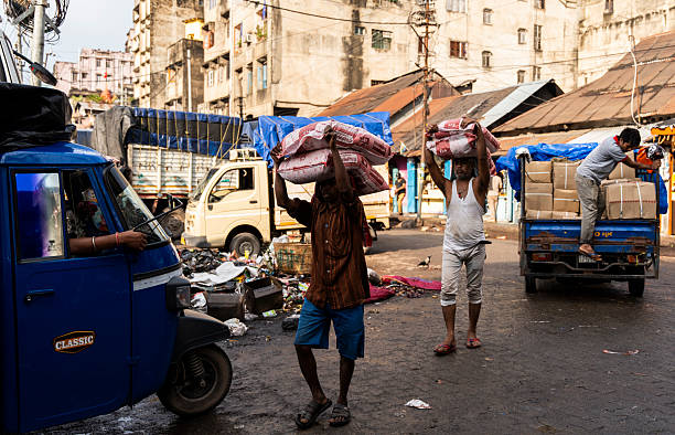 Labourers carries sacks of rice on head in a wholesale market, in Guwahati, India, on  May 1, 2025.   May Day or Workers Day is a global holiday celebrated on May 1st to honor workers and their contributions.
