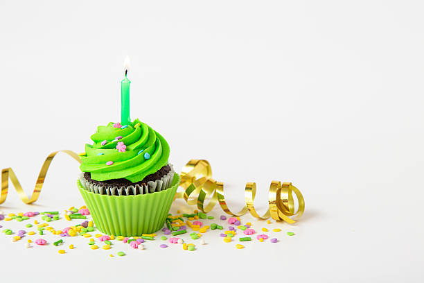 istock Colorful birthday cupcake with candle and festive decorations 2212997313