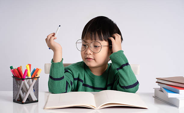 istock Portrait of an Asian boy studying on a white background 2212997402