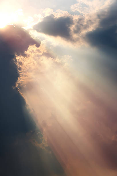 istock Mysterious and fantastic sunlight shining through the clouds, bright and intense rays of light, beautiful sky background 2212998917