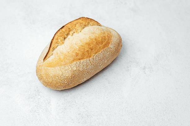 istock Freshly baked bread roll on a light surface for delicious meals 2212998952
