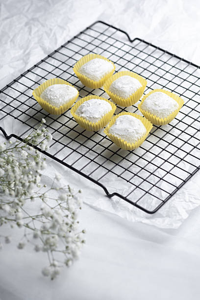 Freshly baked confections cooling on a wire rack in a cozy kitchen