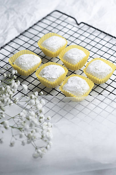 istock Delicate sweets arranged on a wire rack with floral accents in a bright setting 2212998976
