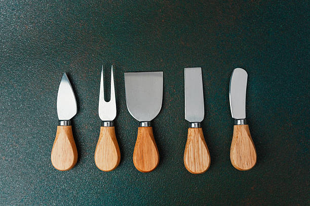 istock Five essential tools for crafting and serving cheese on a wooden board 2212999018