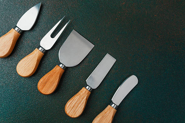 istock Various tools for cheese preparation displayed on a dark countertop 2212999019