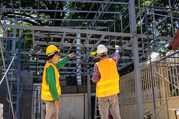 istock Male engineer uses tablet and blueprints to plan warehouse construction work 2213002197