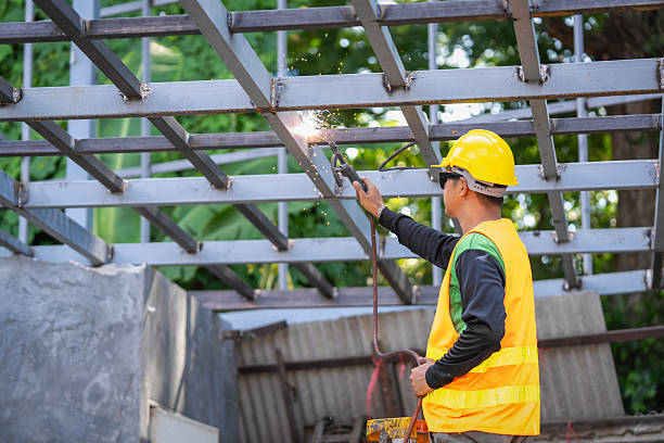 Male engineer welding steel at construction site