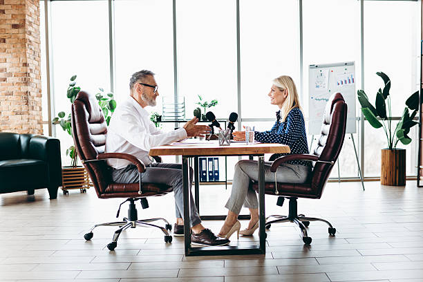 istock Professional business conversation in a modern office, showcasing teamwork and partnership between senior coworkers 2213005093