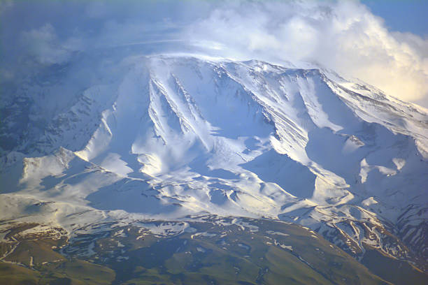 Beautiful landscape with a mountain range. Mountain top. Rocky mountain covered with snow