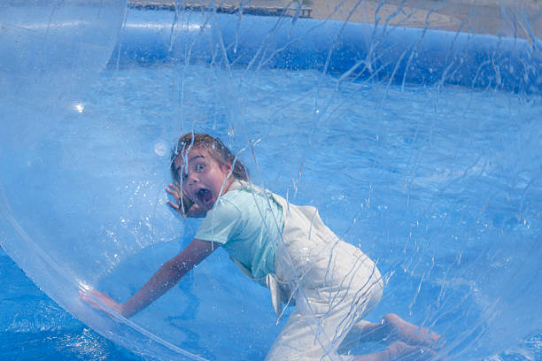 Attraction balloon on the water with a child inside.