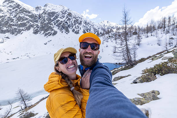istock Couple Taking a Selfie in Snowy Mountain Landscape 2213007526