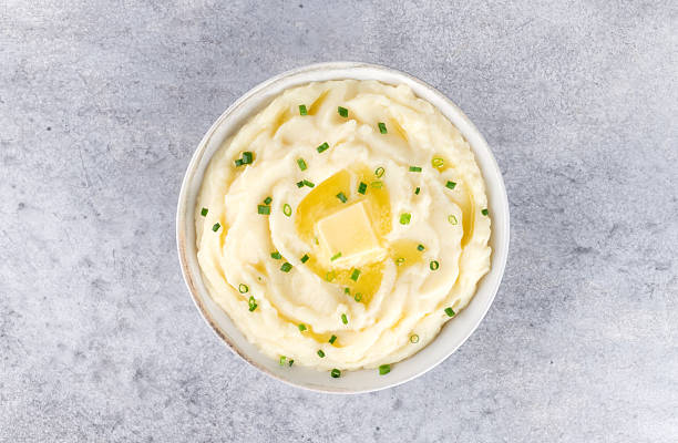 istock Champ mashed potatoes with green onions in white plate on grey background, top view. 2213007613