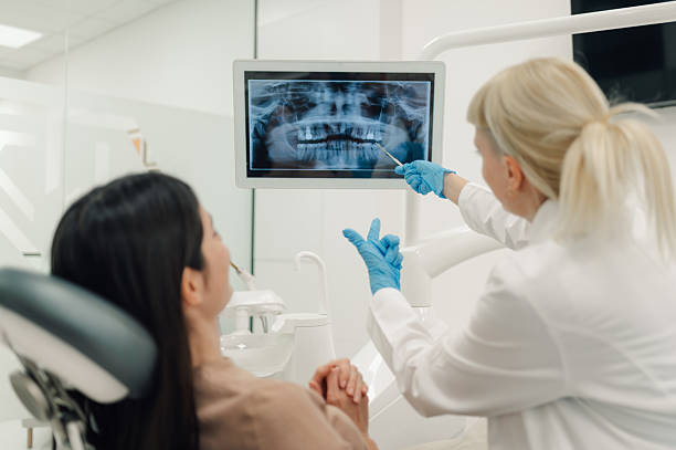 istock Dentist showing teeth x-ray to patient in modern clinic 2213007901