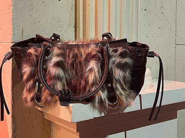 istock fur detailed leopard leather brown bag shot on a white wall 2213013944