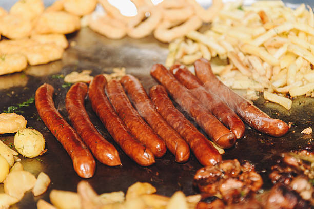 istock fried sausages in large pan outdoors 2213014965