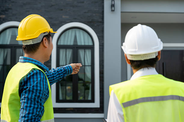 istock inspector engineer and owner project is inspecting construction and quality assurance new house. Engineers or architects or contactor work to build the house before handing it over to the homeowner 2213016020