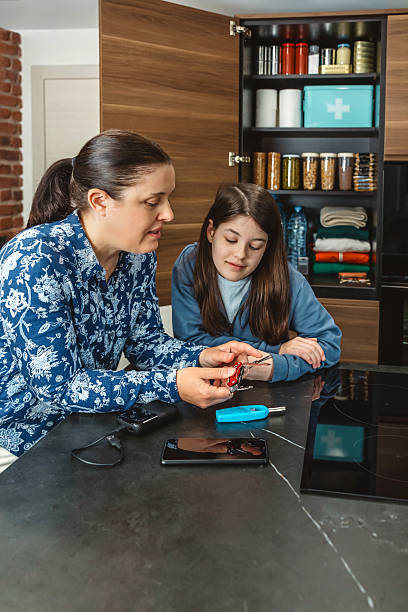 istock Family checking multi purpose knife while preparing 72 hours survival kit in kitchen 2213016170