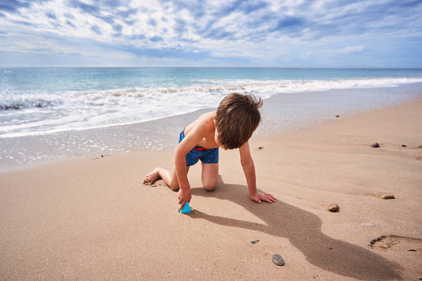caucasian Little boy walking in the beach