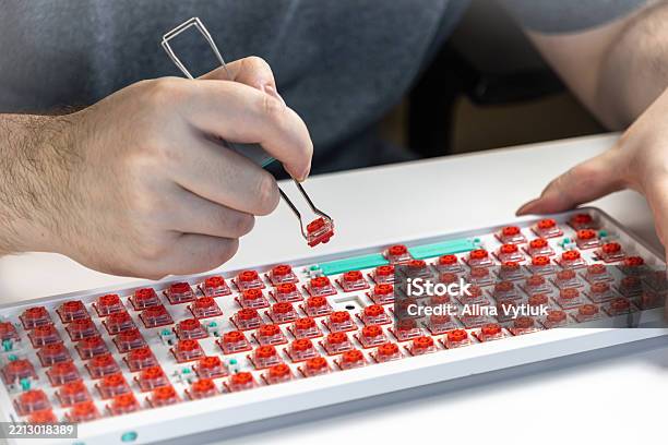 Person Using Switch Puller Tool To Remove Red Switch From Mechanical ...