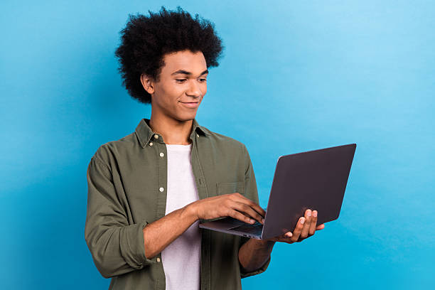 istock Photo of handsome man hold netbook write  email networking isolated on blue color background 2213018848