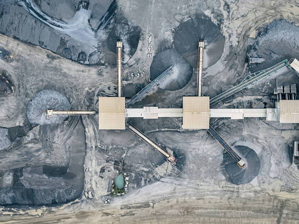 istock Mining operation from above, showing machinery and mounds of extracted resources. 2213019753