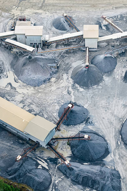 istock Mining operation from above, showing machinery and mounds of extracted resources. 2213019854