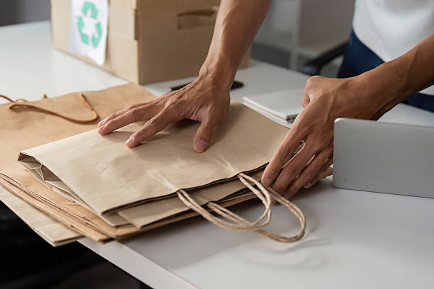 istock Person sorting and preparing paper bags for recycling, highlighting sustainable practices. 2213023342