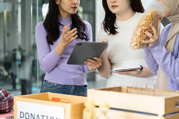 istock Women discussing donation items and community support initiatives 2213023394