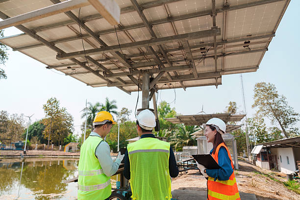 Teamwork and Solar Project Planning. Discussing installation strategies for solar panels at an eco-friendly site.