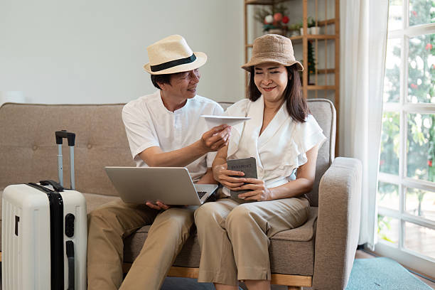 istock Journey and Togetherness. A senior couple planning their next escapade while relaxing at home with travel documents. 2213025352