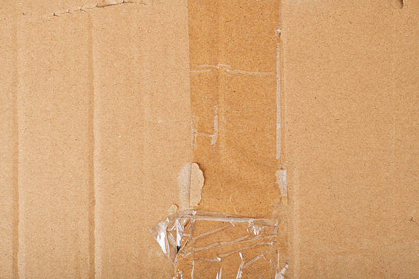 istock Surface of plain cardboard box with transparent plastic covering 2213029822