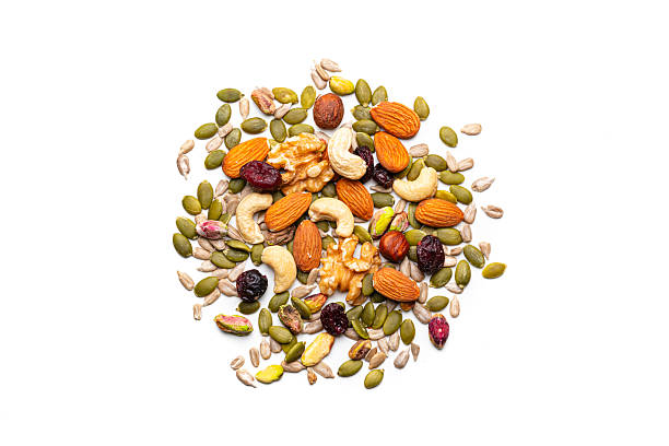 Trail mix: overhead view of nuts and seeds heap isolated on white background