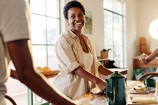 istock Mother preparing the breakfast table with her son, serving Brazilian cheese bread rolls 2213035236