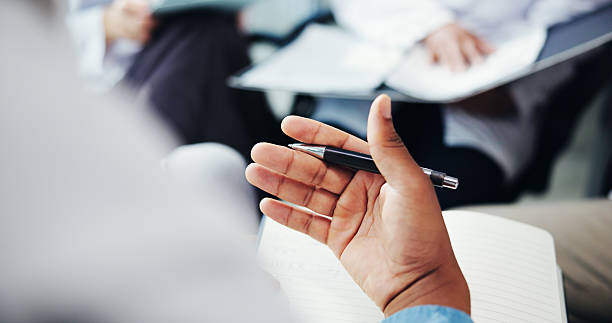 istock Hands, doctor and explain with book for healthcare training, teaching lesson and study information. Teacher, notes and group of students for medical education, class checklist and feedback of interns 2213035653
