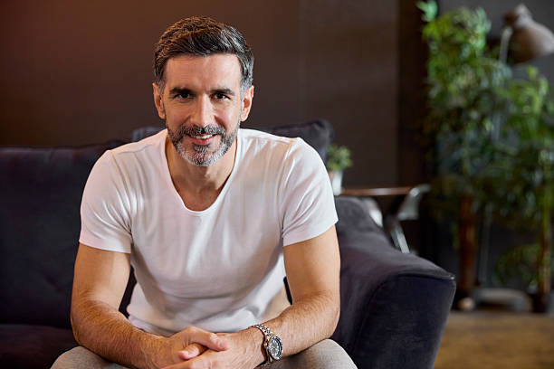 istock Portrait of smiling freelancer sitting on sofa 2213038349