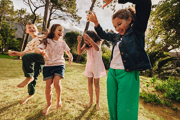 istock Children playing outdoors joyfully under sunlight in a beautiful garden 2213039904