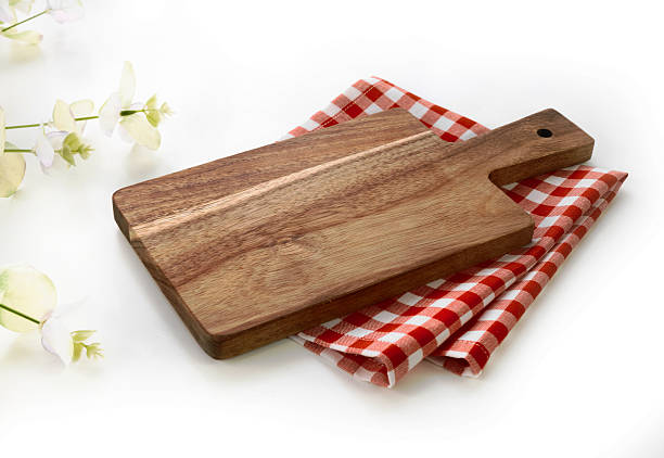 istock Red kitchen towel and wooden board on table 2213042357