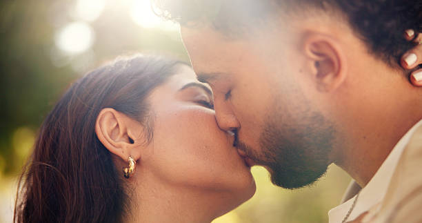 Hug, kiss and romance for couple, outdoor and bonding for commitment in relationship and affection. Park, man and woman on date with love, care and celebration for anniversary, nature or people