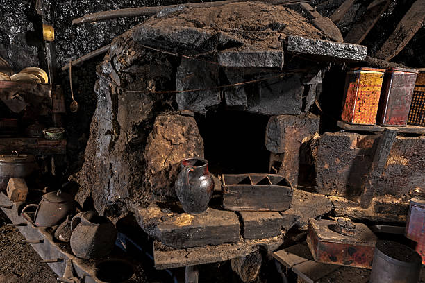 istock Old wood-burning oven in a rural kitchen blackened by smoke 2213043392