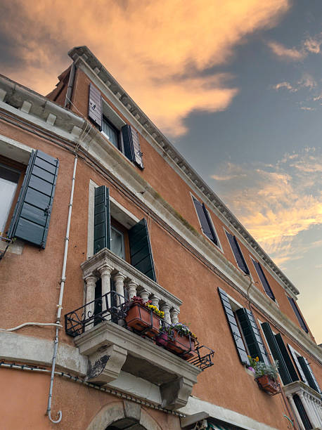 Old European building with balconies at sunset